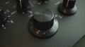 Close-up View of a Black Control Knob Showing Directional Markings and Audio Settings on a Modern Sound Mixing Device in Royalty Free Stock Photo