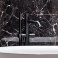 Close-up on black bathtub faucet Royalty Free Stock Photo