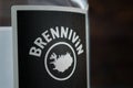 Close-up of a black Brennivin label against a dark wooden background. Selective focus. Traditional Icelandic spirits.