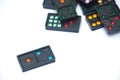 Close up black color dominoes with colorful dot pieces lie. Royalty Free Stock Photo