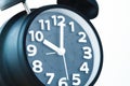 Close up of black color vintage alarm clock on white wall, time Royalty Free Stock Photo