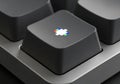 Close-up of a black computer keyboard key featuring a multicolored square icon with Royalty Free Stock Photo