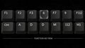 Closeup of a black computer keyboard with various keys highlighted including function keys and letter keys Royalty Free Stock Photo