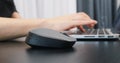 Close up of black computer wireless mouse. Woman working on laptop using mouse, extra close up. Success business concept