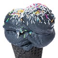 Close up of black cone, wafer cup with scoops of black ice cream and decorated sprinkles is isolated on background