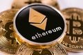 Close Up Of Black Crypto Currency Ethereum Coin Among Golden Bitcoins. Ethereum Domination Concept Royalty Free Stock Photo