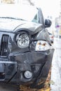 Damaged car, accident. Deformation of the front of a black car Royalty Free Stock Photo