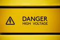 Close up of black danger high voltage sign on yellow background Royalty Free Stock Photo