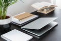 Close-up on black desk with plant, books and laptop in modern freelancer`s interior Royalty Free Stock Photo