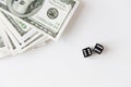 Close up of black dice and dollar money on table