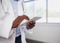 Close up of Black doctor entering patient information into digital tablet