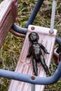 Black Doll Lying On Dirty Swing At Abandoned Playground