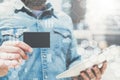 Close-up of black empty credit, business, calling, visiting card and digital tablet in hand of young businessman.