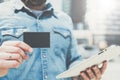 Close-up of black empty credit, business, calling, visiting card and digital tablet in hand of young businessman. Royalty Free Stock Photo