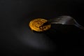 Close-up Black food plate, with fork and spoon, and golden bitcoin on black background Royalty Free Stock Photo