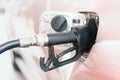 Close up black fuel nozzle filling high energy power fuel into auto car tank in petrol station, commercial service for benzine,