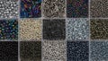 Close up of black and gray seed beads in square sections flat lay background Royalty Free Stock Photo