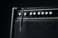 Close up of Black guitar amplifier with jack cable Royalty Free Stock Photo