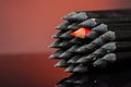 Close up of black identical pencils and one different red Royalty Free Stock Photo