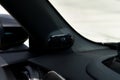 Close up of black luxury car with speaker mounted in side panel. Installed round gadget for qualitative sound in black