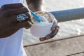 close up of black male hands taking a small vanilla dulce de leche ice cream cup Royalty Free Stock Photo