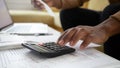 Close up black man hand using calculator and laptop. Royalty Free Stock Photo