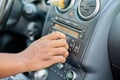 Close-up of a black man& x27;s hand adjusts the volume of the car stereo system. Royalty Free Stock Photo