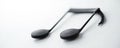 Close up of a black musical note against a bright white background , texture, notation Royalty Free Stock Photo