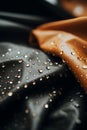 a close up of a black and orange fabric with water droplets on it Royalty Free Stock Photo