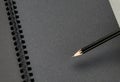 Close up at black pencil on blank black notebook,mock up for add Royalty Free Stock Photo