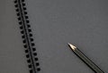 Close up at black pencil on blank black notebook,mock up for adding your content Royalty Free Stock Photo