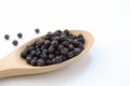 Close up black pepper seeds or peppercorns ( dried seeds of piper nigrum) in wooden spoon. Royalty Free Stock Photo