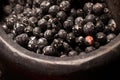 close-up of black peppercorns in a stone mortar, mid-crush Royalty Free Stock Photo