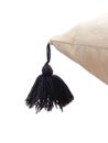 Close up of black pom pom on natural cotton cushion. Detail of pillow with edges pompom. White background. Black Decorative Pompom Royalty Free Stock Photo