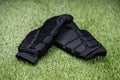 Black Shin Guards On Green Turf Background Royalty Free Stock Photo