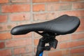 Close-up of a black saddle of a modern mountain bike. Outdoors Royalty Free Stock Photo