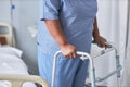 Close up of black senior woman leaning on walker support in hospital room