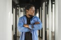 Close-up black serious male face in profile. Man stand with arms folded. Portrait of pensive african american man Royalty Free Stock Photo