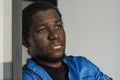 Close-up black serious male face in profile. Man stand with arms folded. Portrait of pensive african american man Royalty Free Stock Photo