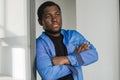 Close-up black serious male face in profile. Man stand with arms folded. Portrait of pensive african american man Royalty Free Stock Photo