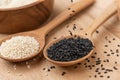 Close up of black sesame and white sesame seed on wooden spoon in kitchen Royalty Free Stock Photo