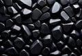 Close-up of black, shiny rock stone wall with black background, post-minimalism, angular, matte background, black background
