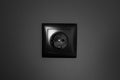 Close-up of black socket on  background of grey wall. Royalty Free Stock Photo