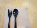 Black Spoon and Fork with Tissue Paper on Wooden Table for Dessert Royalty Free Stock Photo