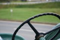 Detail of the steering wheel on an old fashioned metal tractor