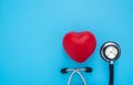 Close-up of Black stethoscope with red heart of doctor for checkup on blue background. Royalty Free Stock Photo