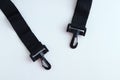 Close-up black textile handle for bag with plastic carabiners