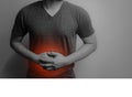 black and white image Man with abdominal pain, stomach ache with red point on gray background Royalty Free Stock Photo