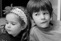 Close up black and white portrait of boy and girl, brother and sister, cuddling