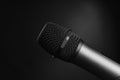 Close-up black and white shot of a microphone in a studio or concert on stage, on a black background Royalty Free Stock Photo